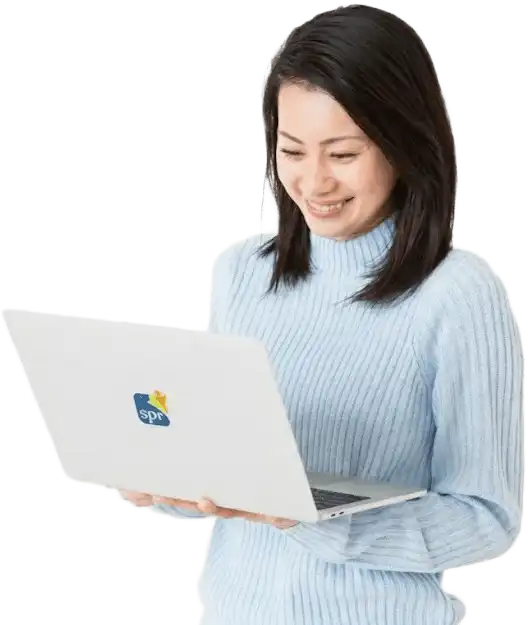 Woman in light blue sweater working on SPR laptop, representing Search Party Recruiting hiring solutions