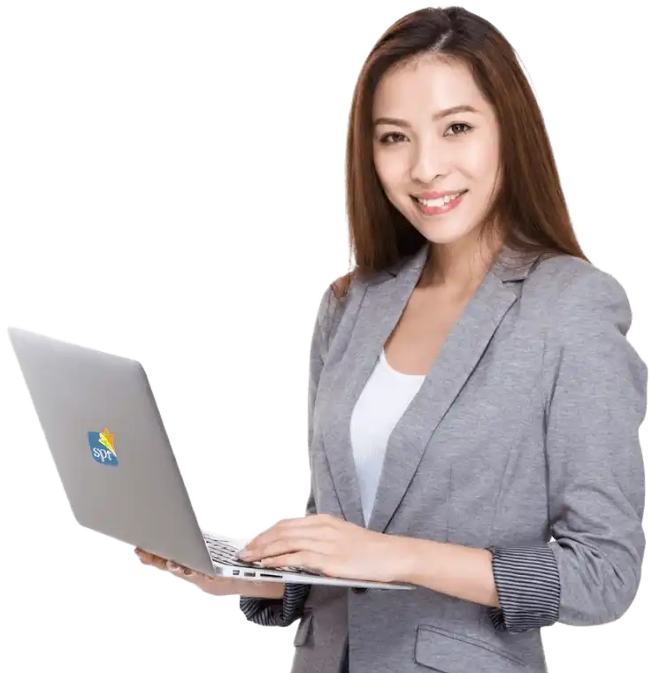 Smiling woman in grey blazer working on SPR laptop, representing Search Party Recruiting&rsquo;s hiring solutions