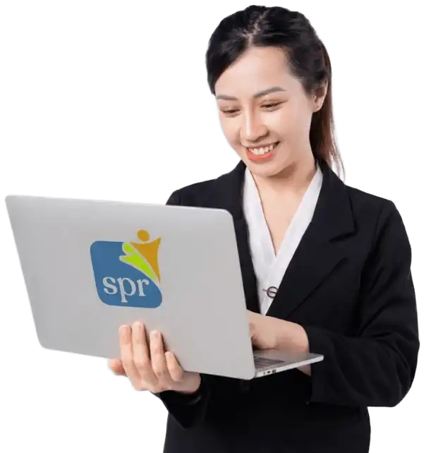 Smiling professional using laptop with SPR logo, representing Search Party Recruiting&rsquo;s remote staffing solutions