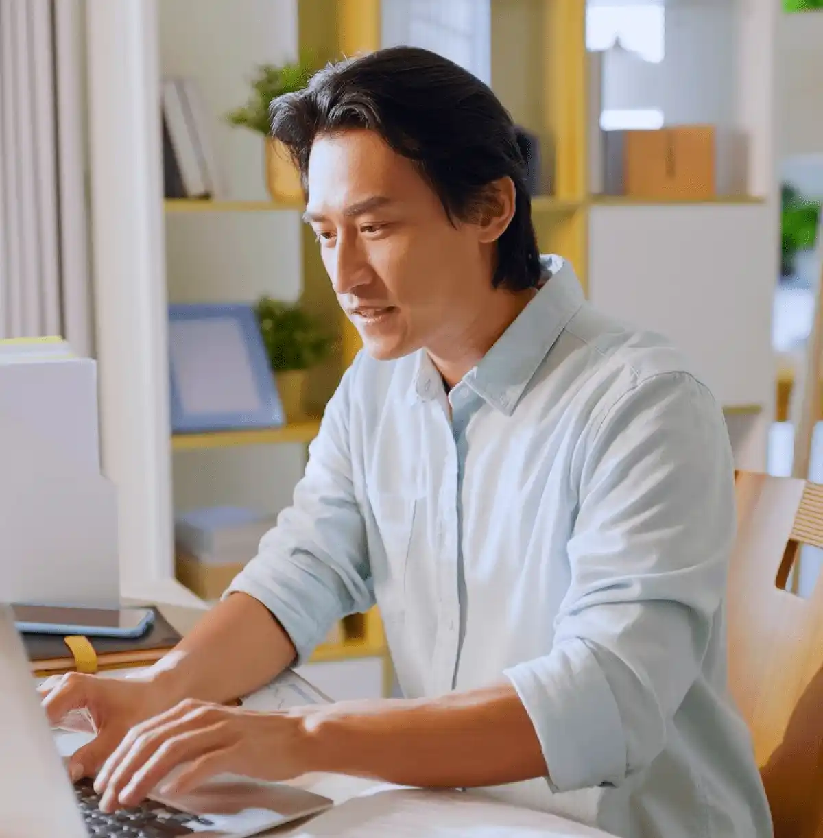 Focused professional working on a laptop at a home office desk, supporting Search Party Recruiting&rsquo;s remote tasks