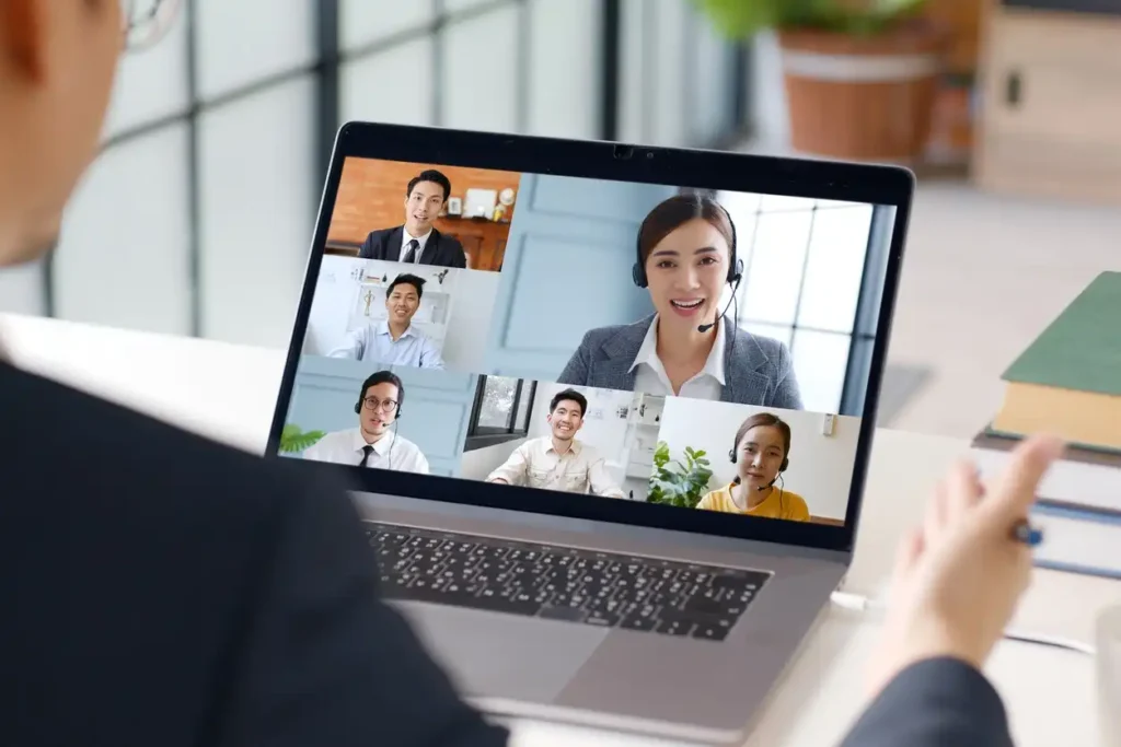 Young Asian businessman work at home and virtual video conference meeting with colleagues business people, online working, video call at home office